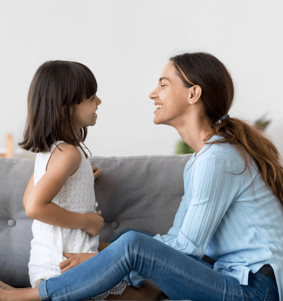 A happy mother smiles at her daughter