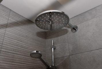 A large luxury rainwater style shower head in bathrooms and en-suites A large luxury rainwater style shower head in bathrooms and en-suites